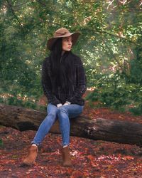 Full length of young woman in park during autumn