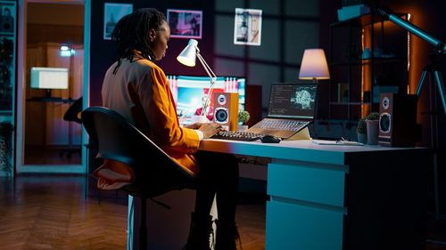 Young woman using laptop while sitting at home