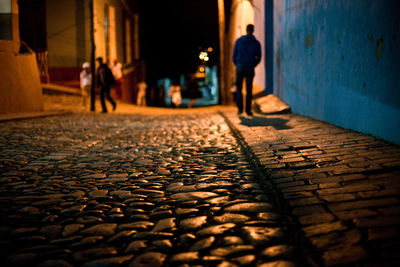 People walking on street in city at night