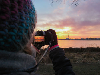Close-up of person photographing at camera
