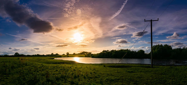 Scenic view of field against sky during sunset