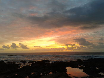 Scenic view of sea against cloudy sky