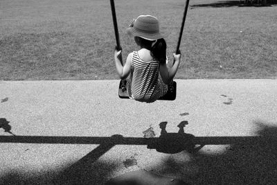 Rear view of a girl on swing