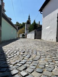 Surface level of footpath by building against sky