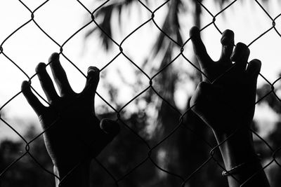Close-up of chainlink fence against sky