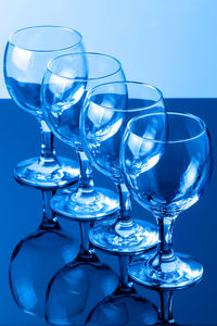 Close-up of wineglasses on blue table