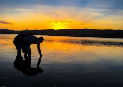 Men at beach during sunset