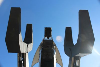 Low angle view of pole against blue sky