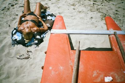 Rear view of a girl sitting outdoors
