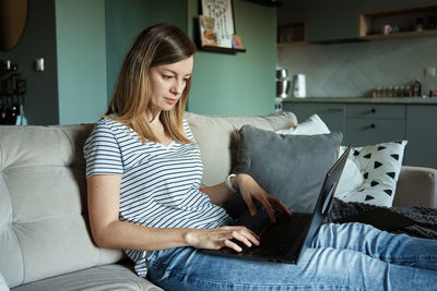 Woman at home using laptop. remote work at home office