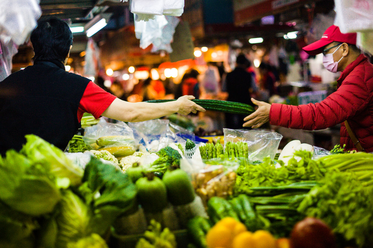 food, retail, vegetable, market, real people, food and drink, women, healthy eating, incidental people, market stall, group of people, buying, selling, freshness, men, people, adult, business, selective focus, lifestyles, sale, street market