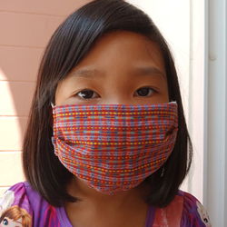 Close-up portrait of a girl covering face