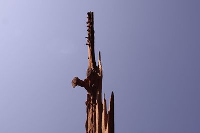 Low angle view of sculpture against clear blue sky