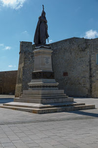 Low angle view of statue against sky