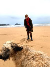 Full length of man with dog on beach