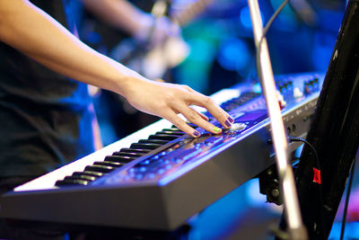 Close-up of hands playing piano