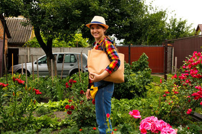 Young woman holding eco totebag or shopper on her shoulder and smiling. eco bag, stop plastic. 