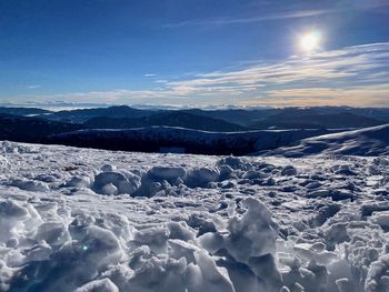 Scenic view of snowcapped mountains against sky during winter