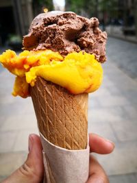 Close-up of hand holding ice cream cone