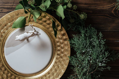 Close-up of deer figurine in plate by plants on table