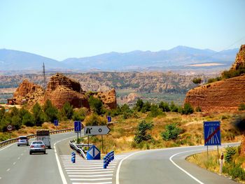 Road by city against clear sky