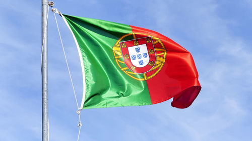 Low angle view of portugal flag against sky