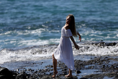 Woman with umbrella on beach