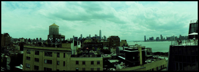 Panoramic view of buildings in city against sky