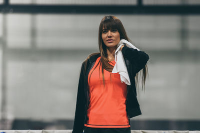 Beautiful girl wipes the sweat after a training session. young sporty woman at the end of the match.