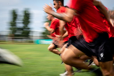 Blurred motion of man running on grass