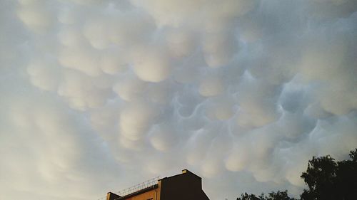 Low angle view of built structure against cloudy sky