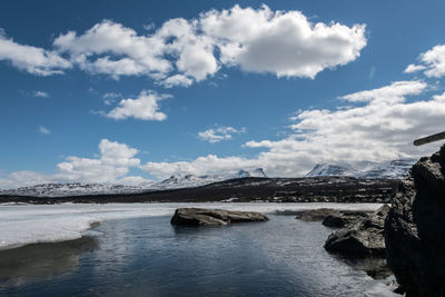 Scenic view of lake against sky during winter