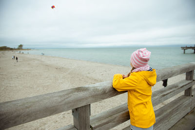 Full length of woman on beach against sky