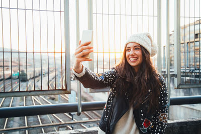 Smiling young woman using mobile phone