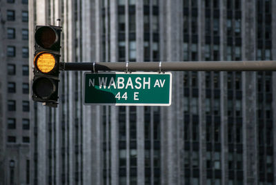 Road sign against building in city