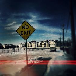 Road sign against clear sky