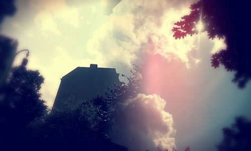 Low angle view of building against cloudy sky