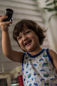 Portrait of smiling girl holding indoors