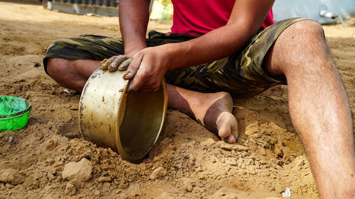 Low section of man working in mud
