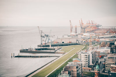 High angle view of commercial dock against sky in city