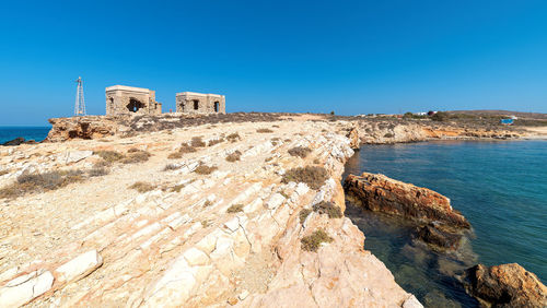 Scenic view of sea against clear blue sky