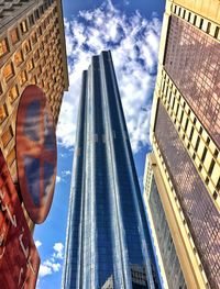 Low angle view of buildings against cloudy sky