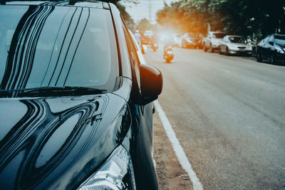 Close-up of car on road