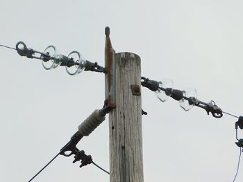 Low angle view of barbed wire against clear sky