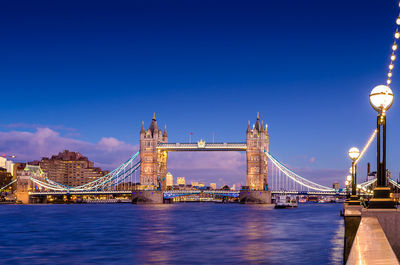 Tower bridge over river against sky