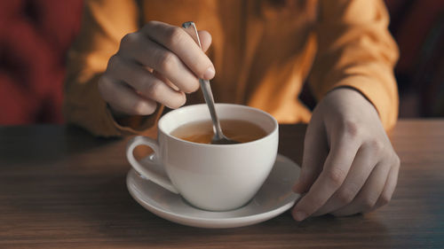 Midsection of woman having tea