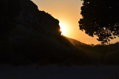 Scenic view of silhouette mountains against sky during sunset