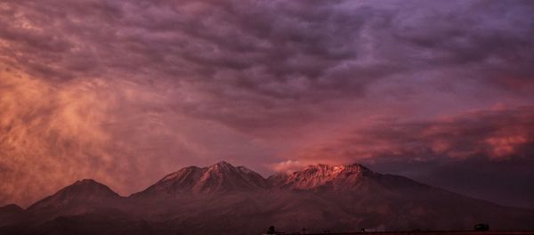 Scenic view of snowcapped mountains against sky during sunset