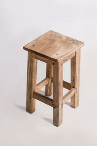 Close-up of wooden structure on table against white background