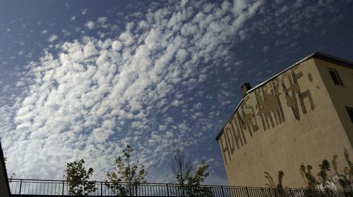 Low angle view of building against cloudy sky